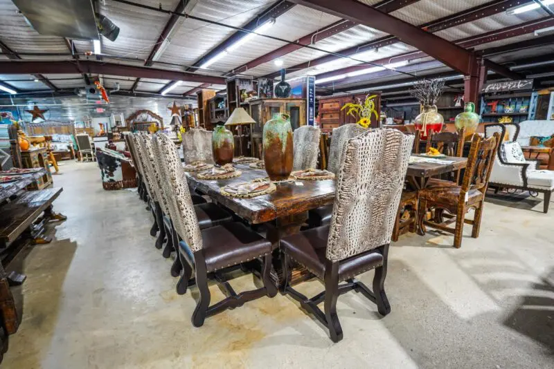 A large dining room table with animal print chairs.