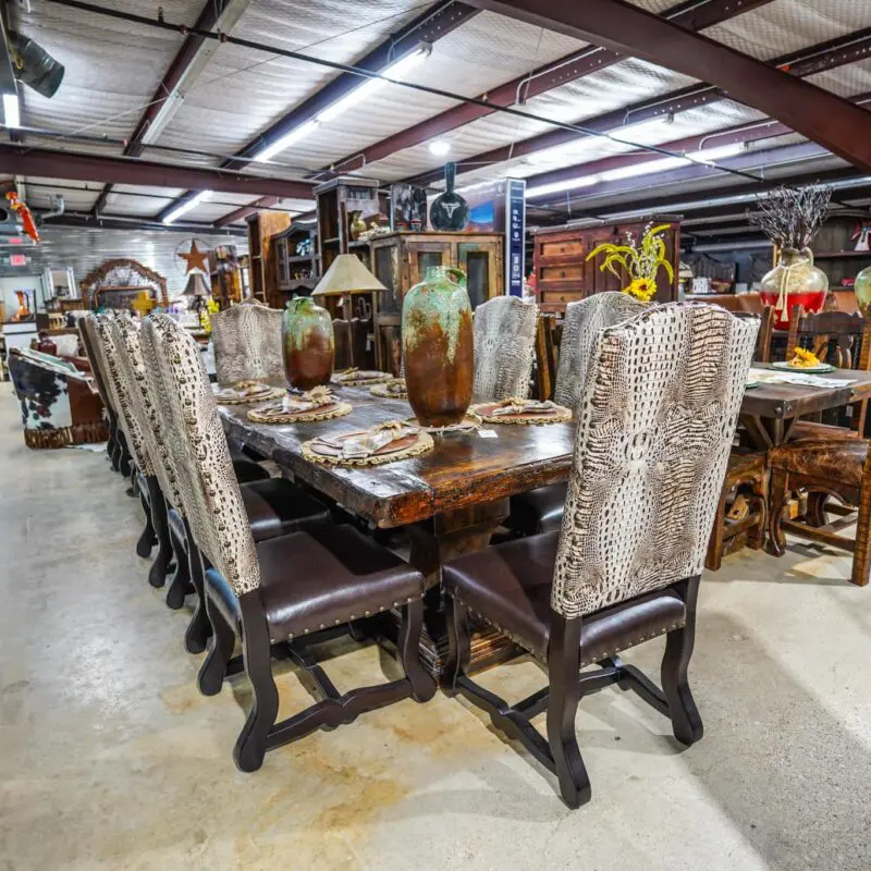 A large dining room table with animal print chairs.