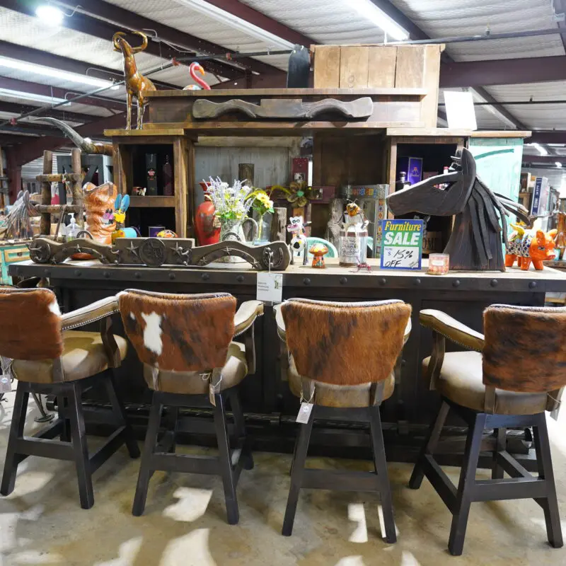 A group of chairs sitting in front of a bar.