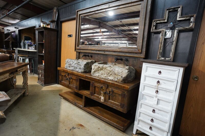 A room filled with lots of furniture and a large mirror.