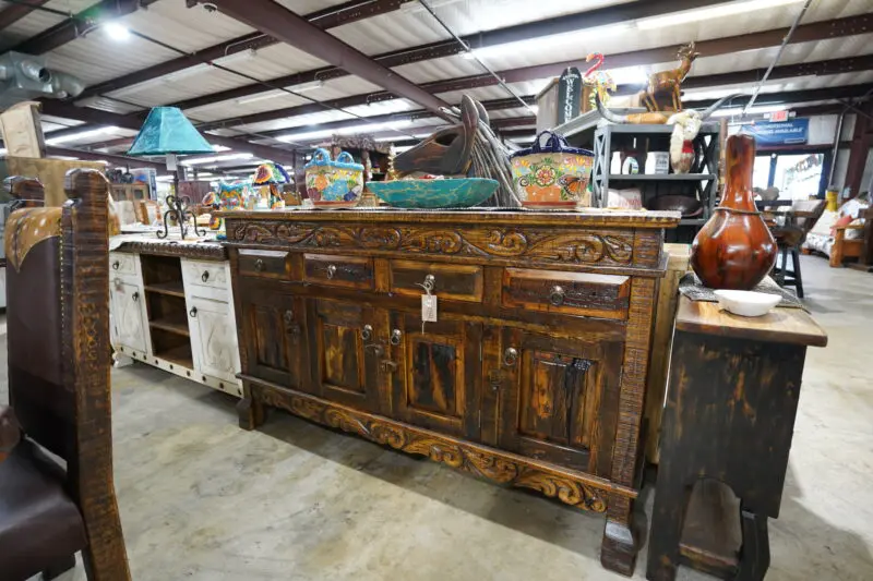 A large wooden buffet with many drawers and shelves.