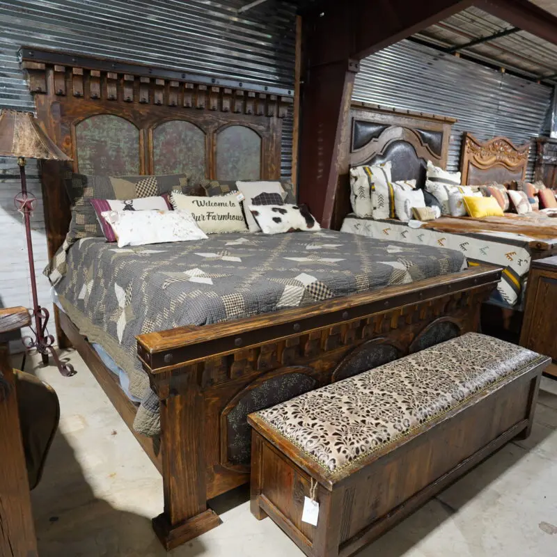 A bed with an ornate headboard and footboard.