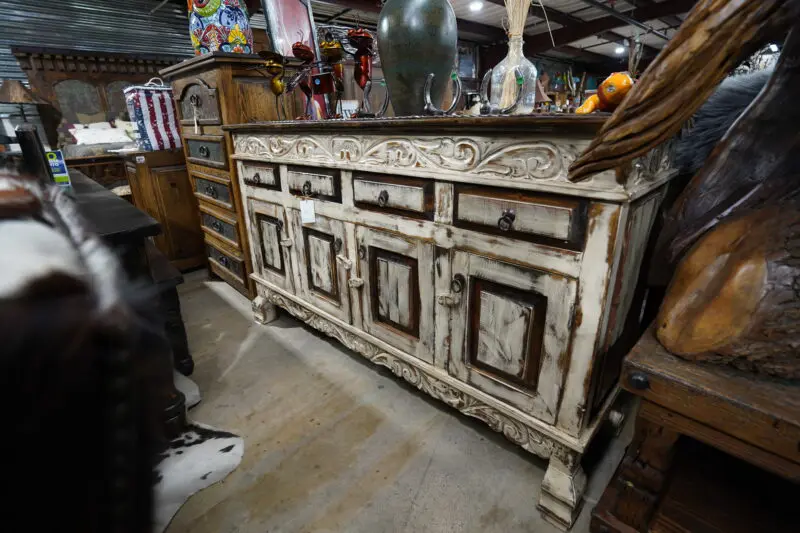 A white cabinet sitting in the middle of a room.