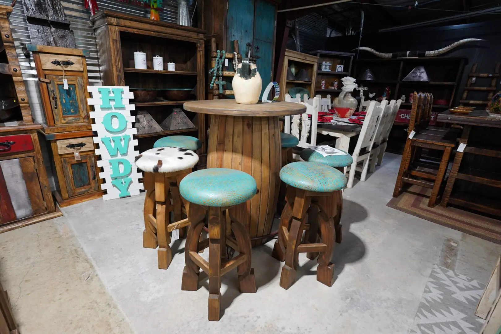 A table with four stools in the middle of it.