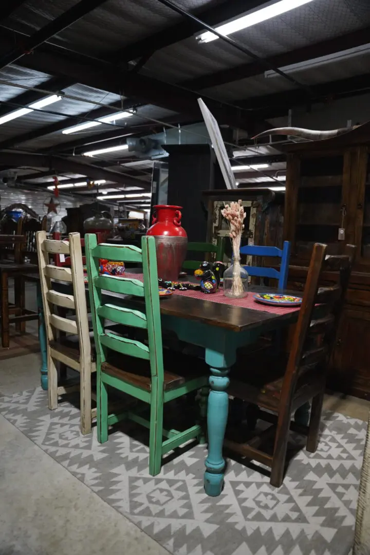 A table with four chairs and a knife on the top of it.