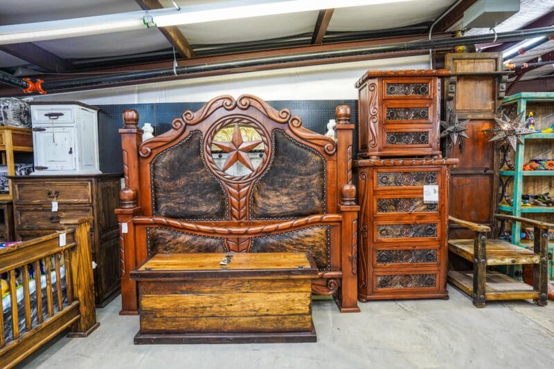 A bed and dresser in a room.