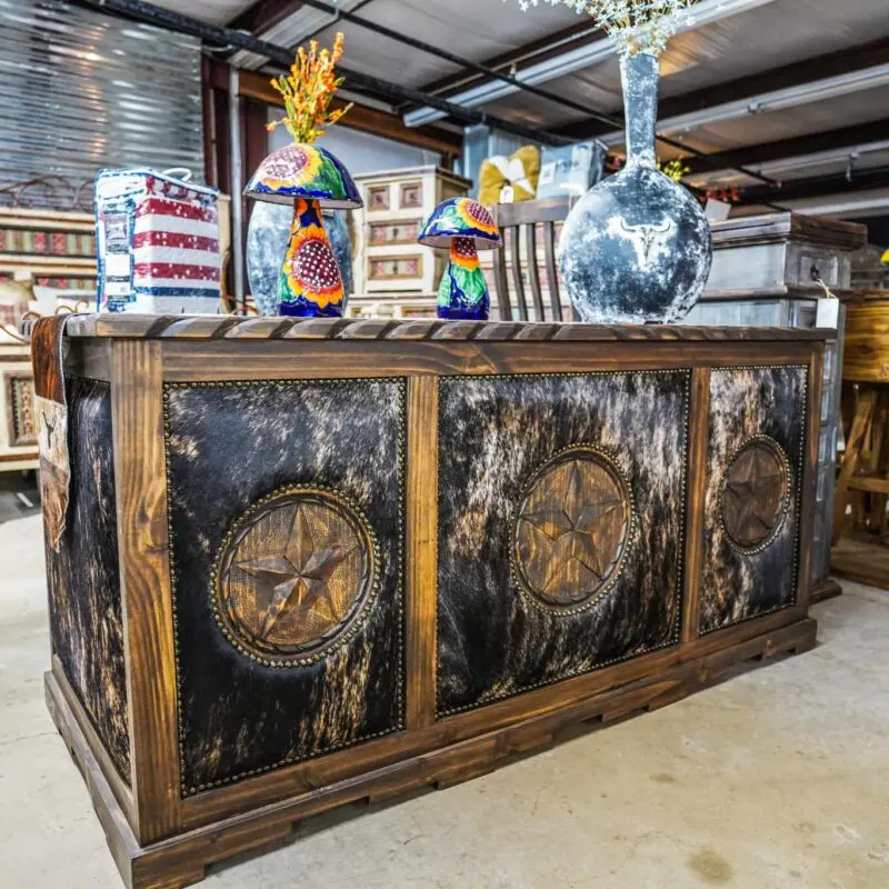 A large wooden table with clocks on it