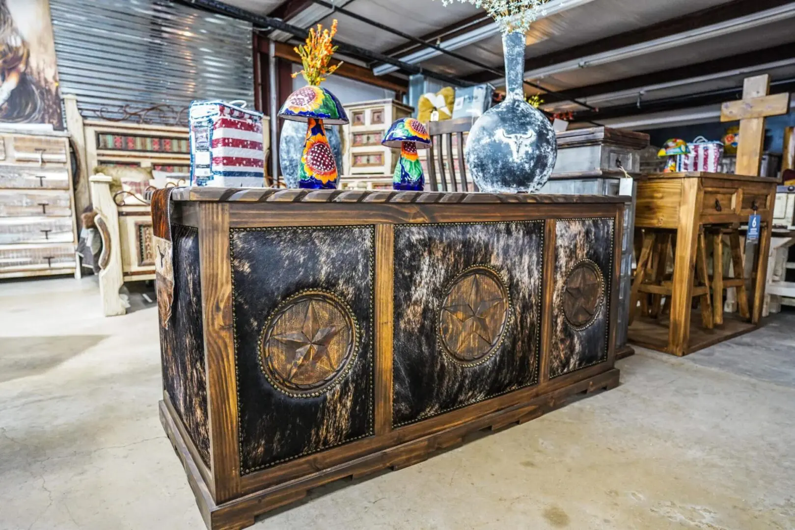 A large wooden table with clocks on it