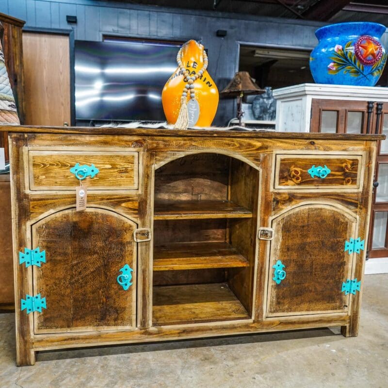 A wooden cabinet with blue trim and turquoise knobs.