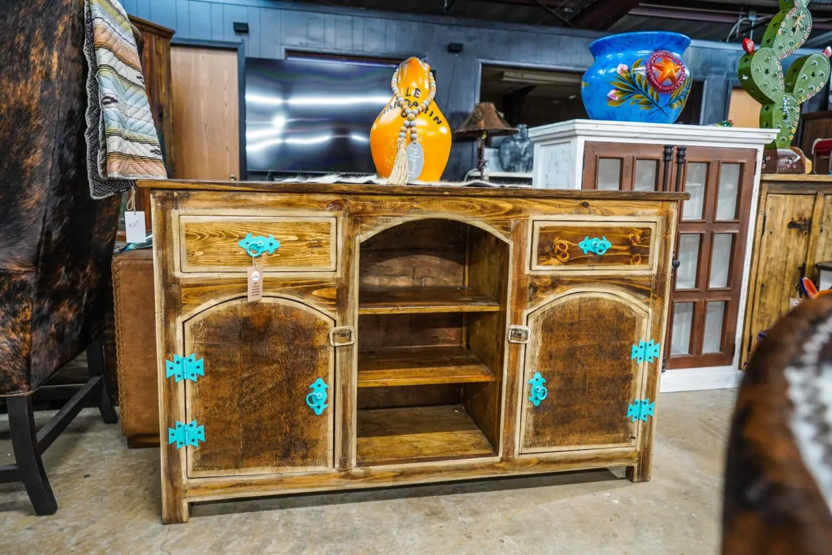 A wooden cabinet with blue trim and turquoise knobs.