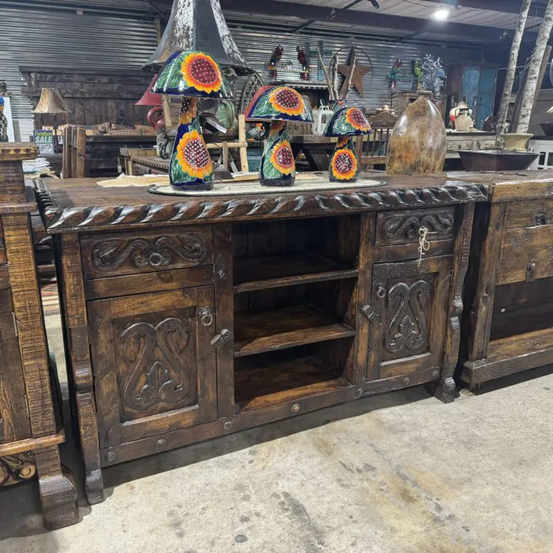 A large wooden buffet with carved designs on it.