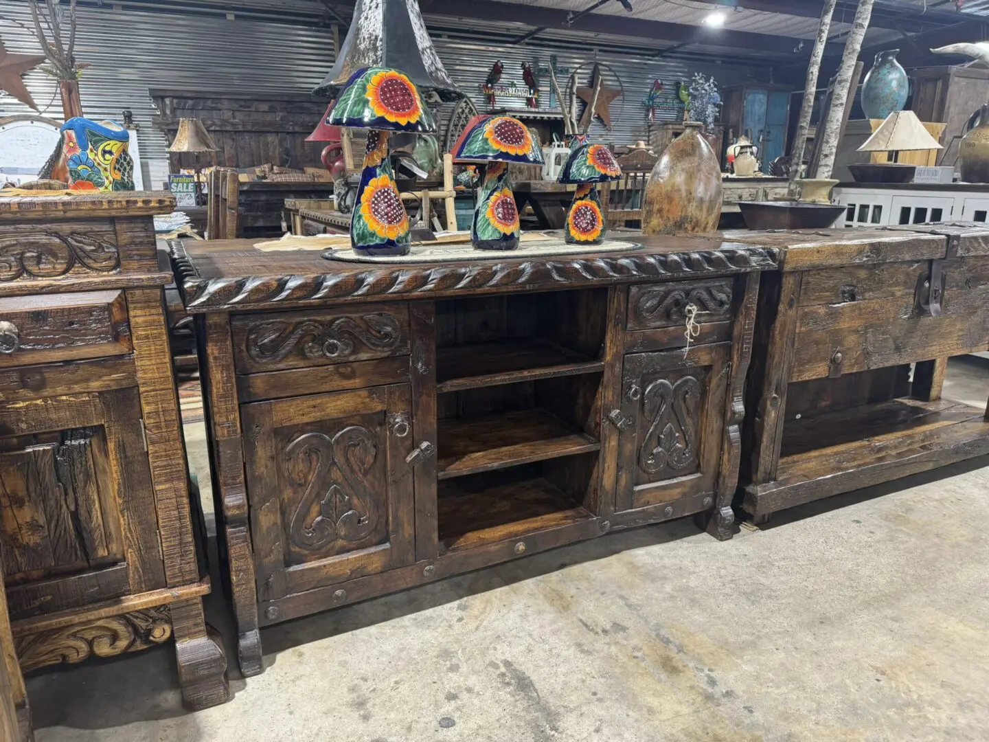 A large wooden buffet with carved designs on it.