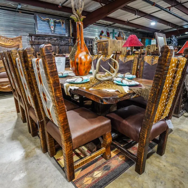 A large dining room table with chairs and plates.