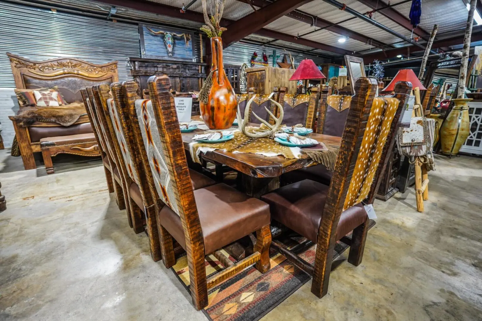 A large dining room table with chairs and plates.