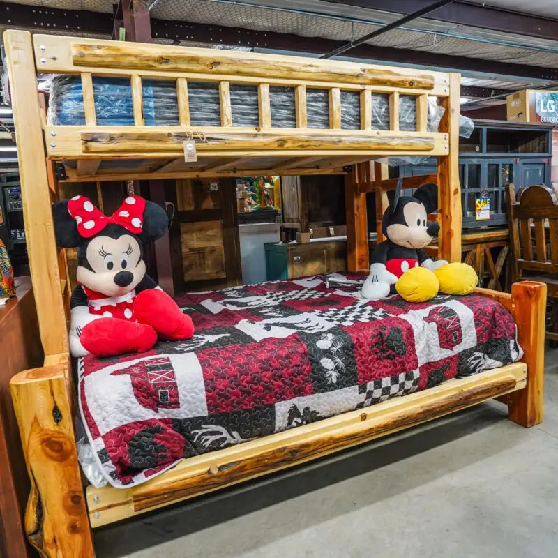 A mickey mouse and minnie mouse bed in a room.