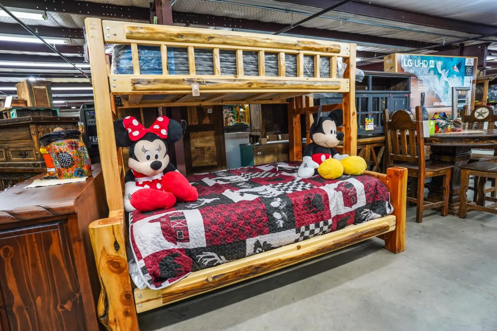 A mickey mouse and minnie mouse bed in a room.