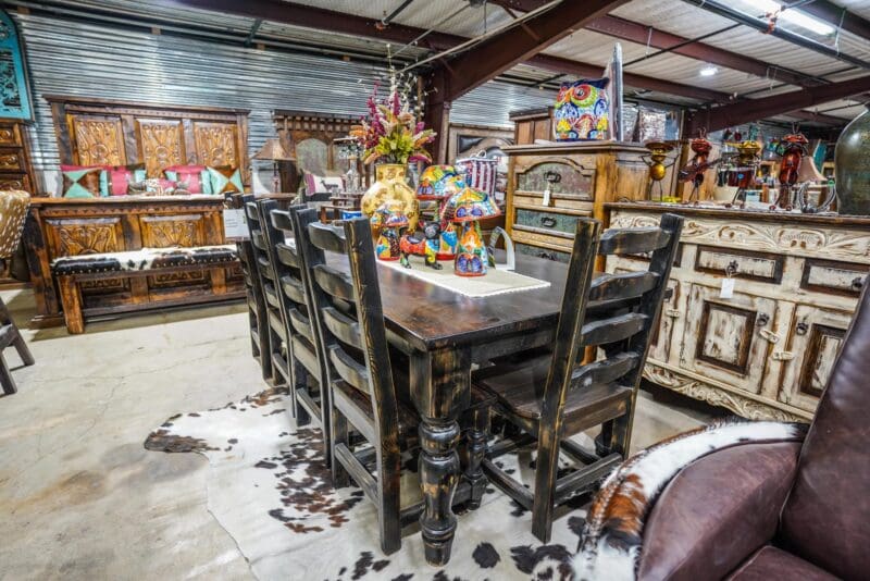 Rustic wood dining set with cowhide rug.