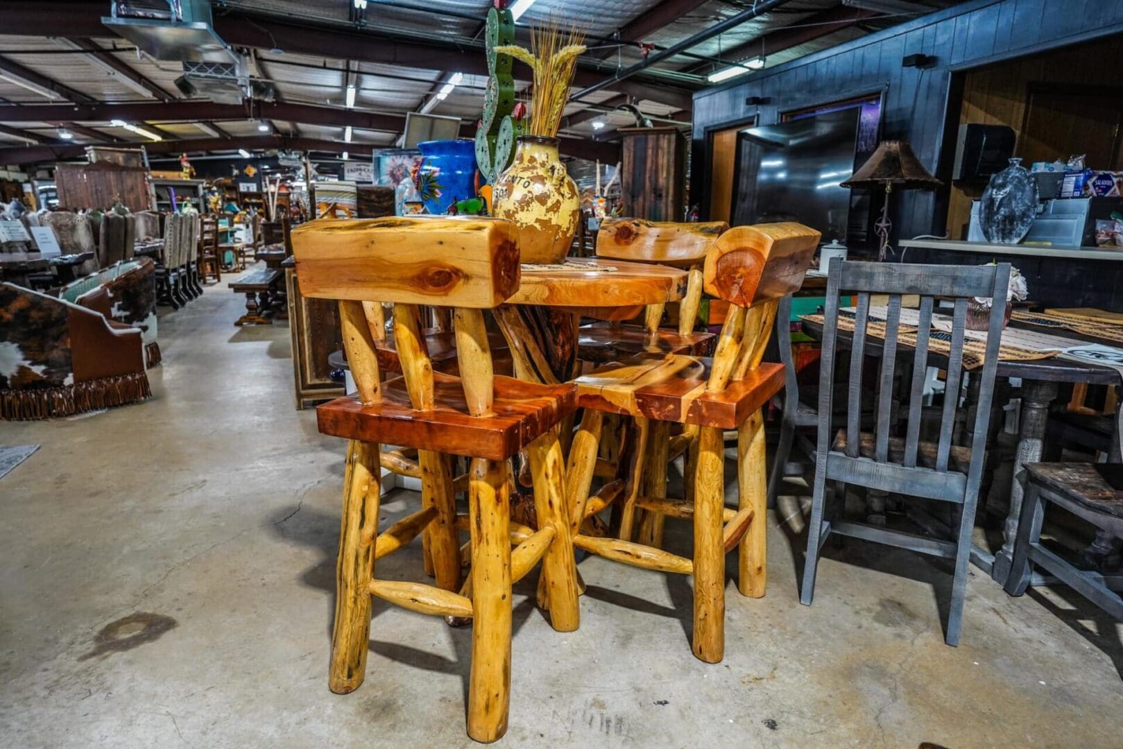 Wooden bar stools and a table in a store.