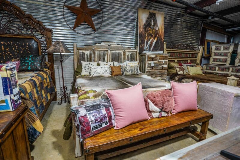 Rustic bedroom furniture with pink pillows.