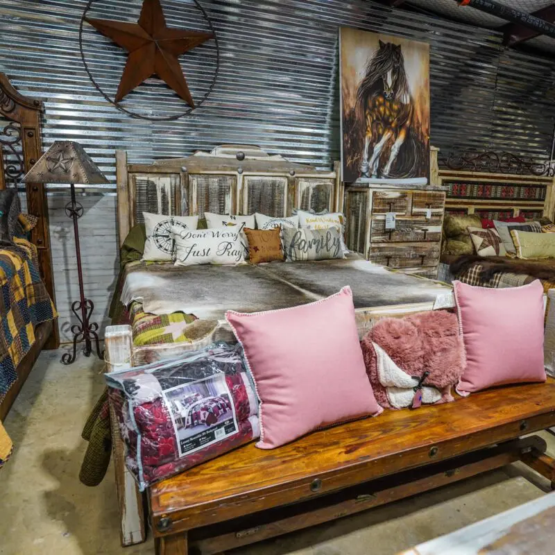 Rustic bedroom furniture with pink pillows.