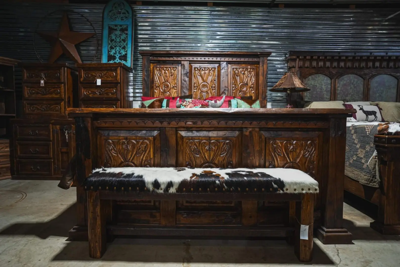 Carved wooden bench with cowhide seat.