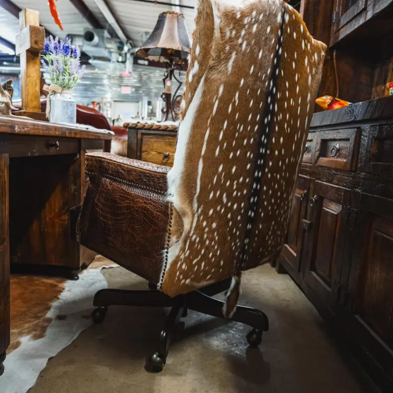 Brown leather chair with deer hide back.