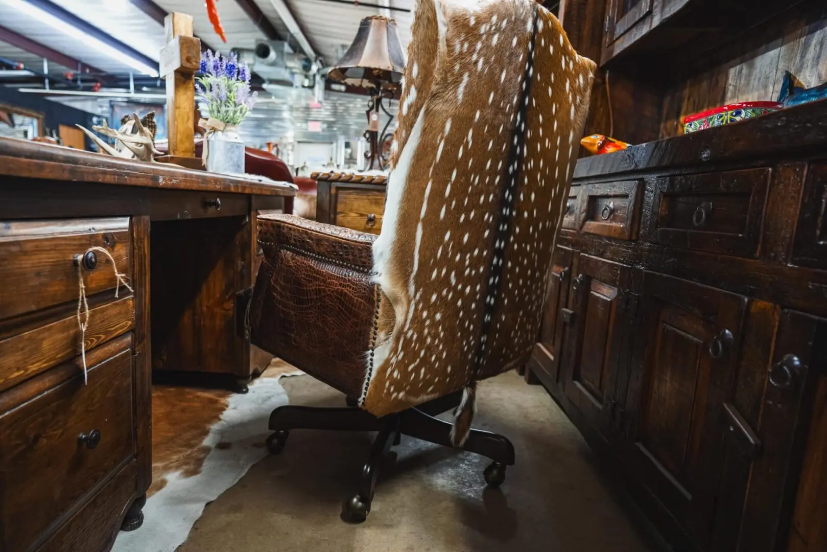 Brown leather chair with deer hide back.