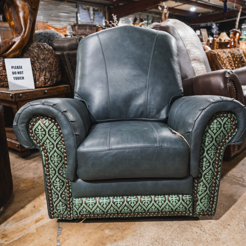 A leather chair with green and blue patterned upholstery.