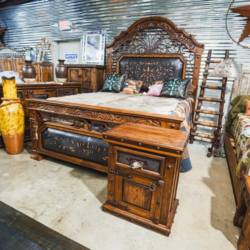 Ornate wooden bed with carved headboard.