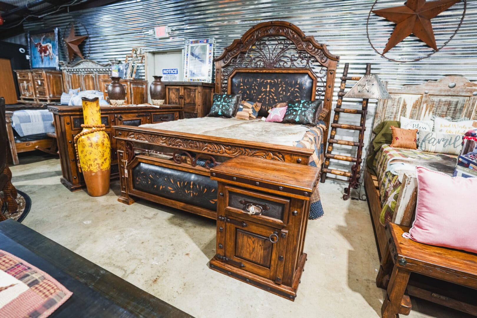 Ornate wooden bed with carved headboard.