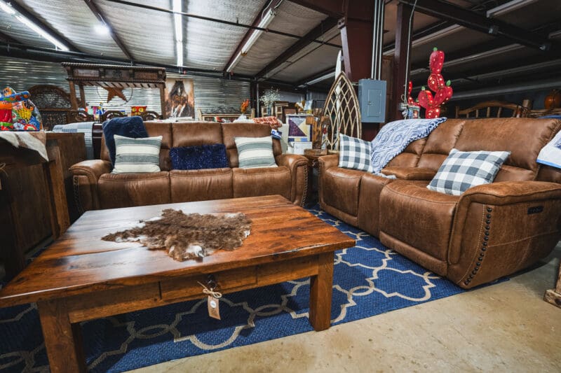 Brown leather sofas with a wood coffee table.