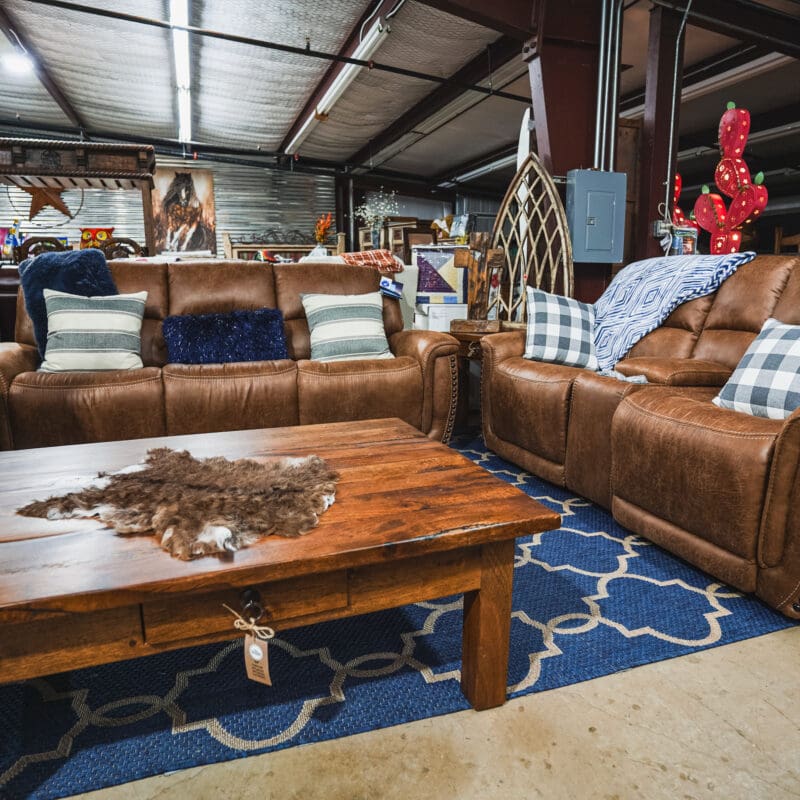 Brown leather sofas with a wood coffee table.