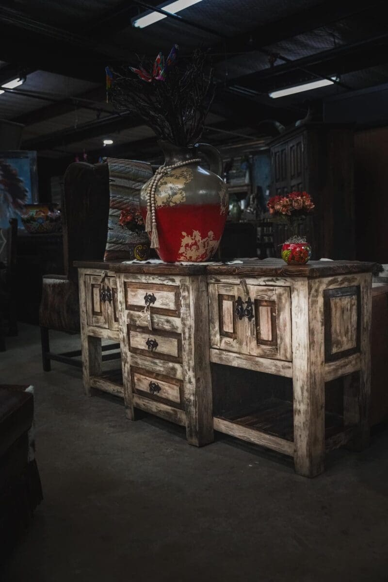 Rustic wooden cabinet with drawers and shelves.