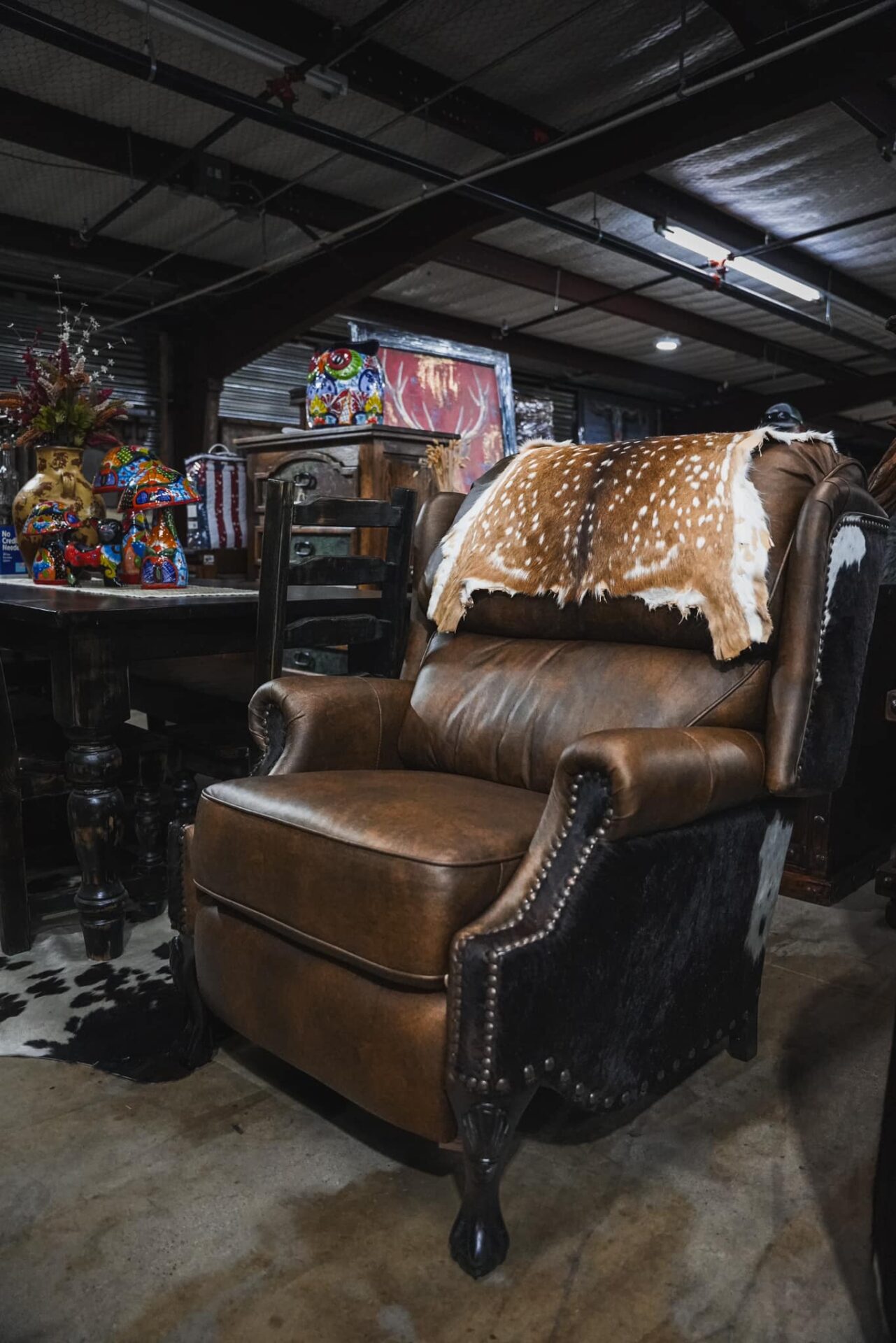 Brown leather recliner with deer hide.