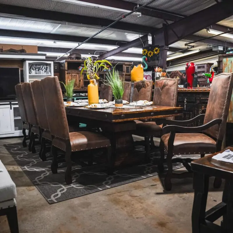 Wooden dining table with leather chairs.