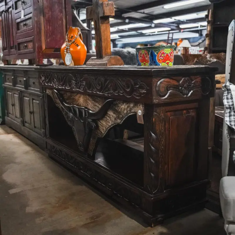 Ornate wooden console with bull head design.