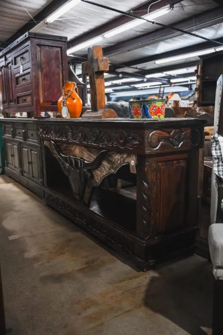 Ornate wooden console with bull head design.