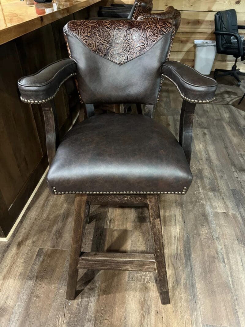 Brown leather bar stool with floral design.