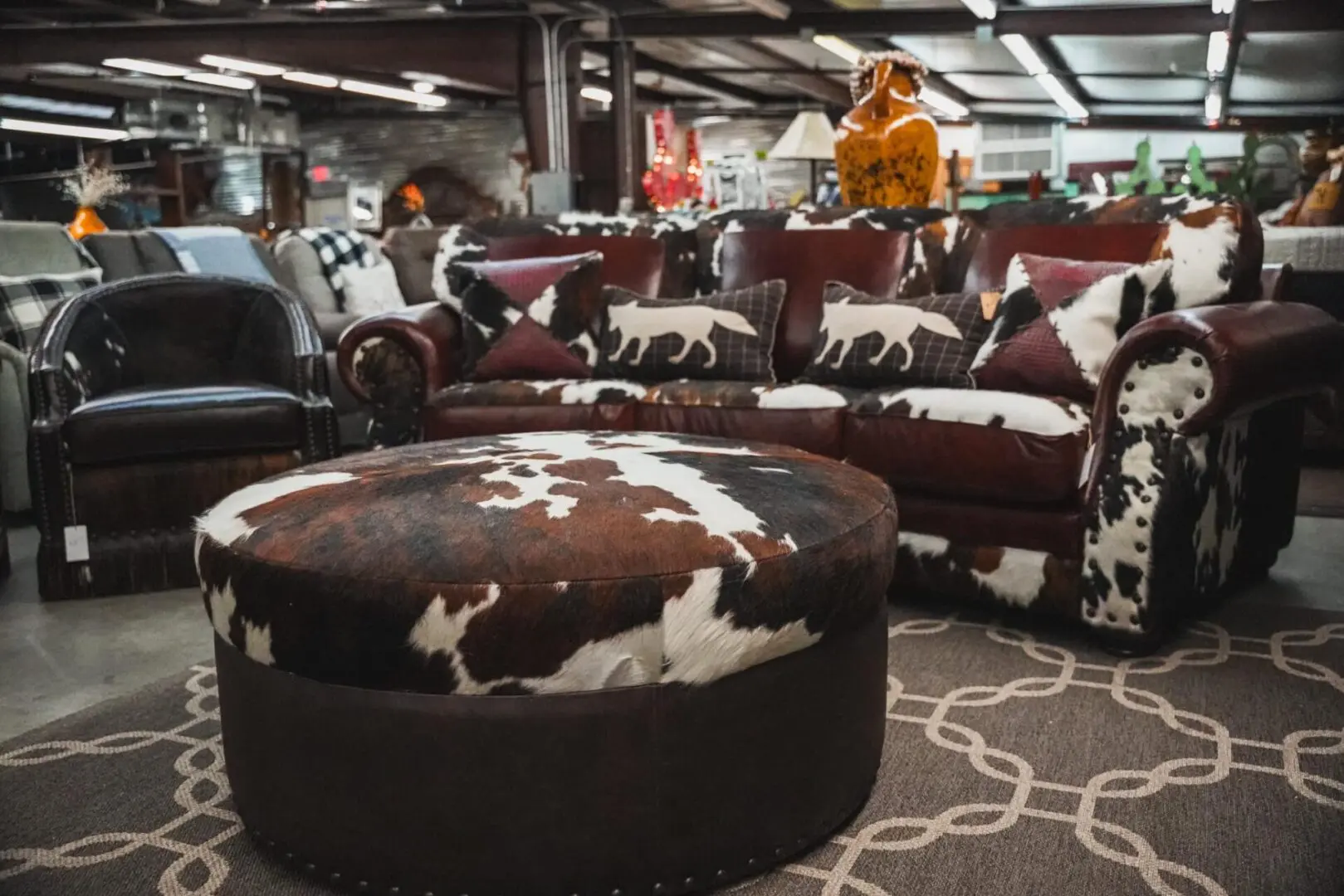 Cowhide ottoman in front of a sofa.