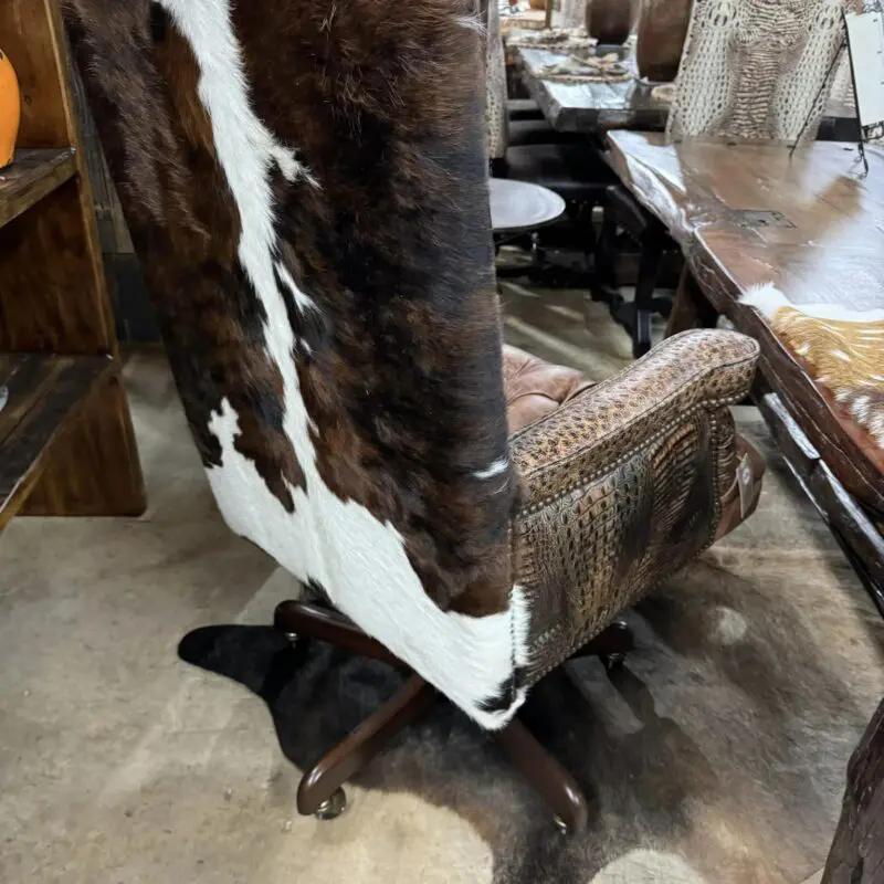 Cowhide office chair on a rug.