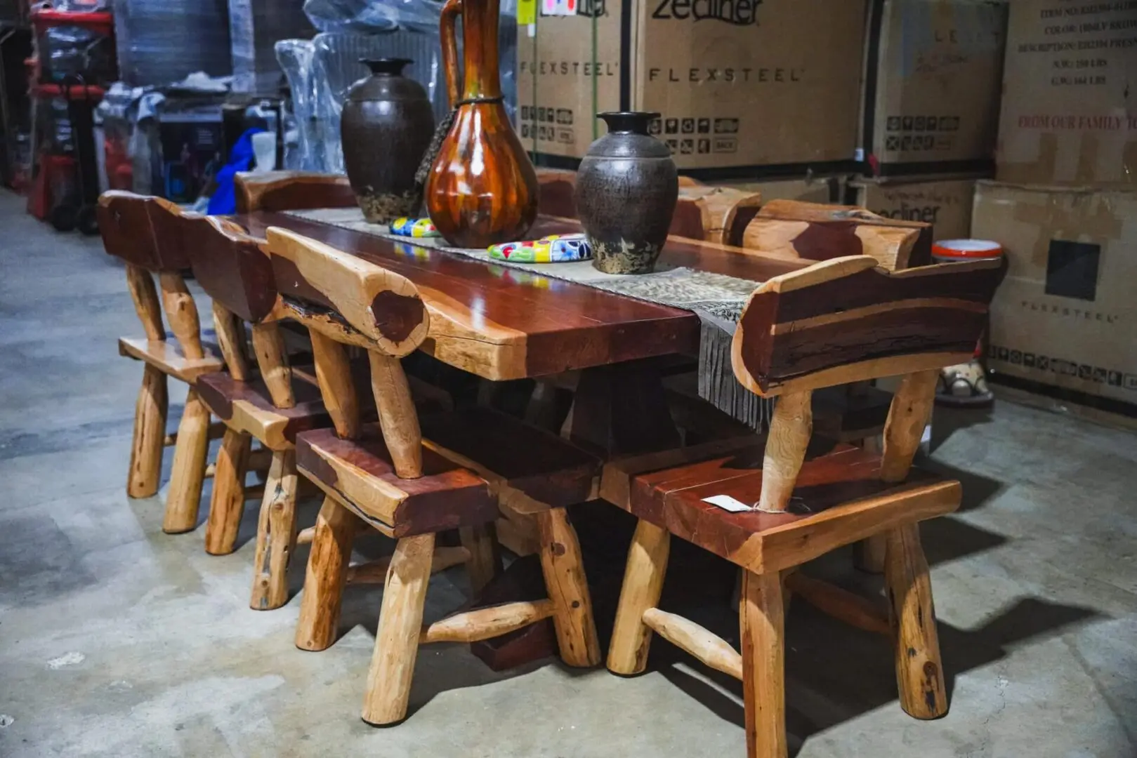 Wooden dining table with chairs and vases.