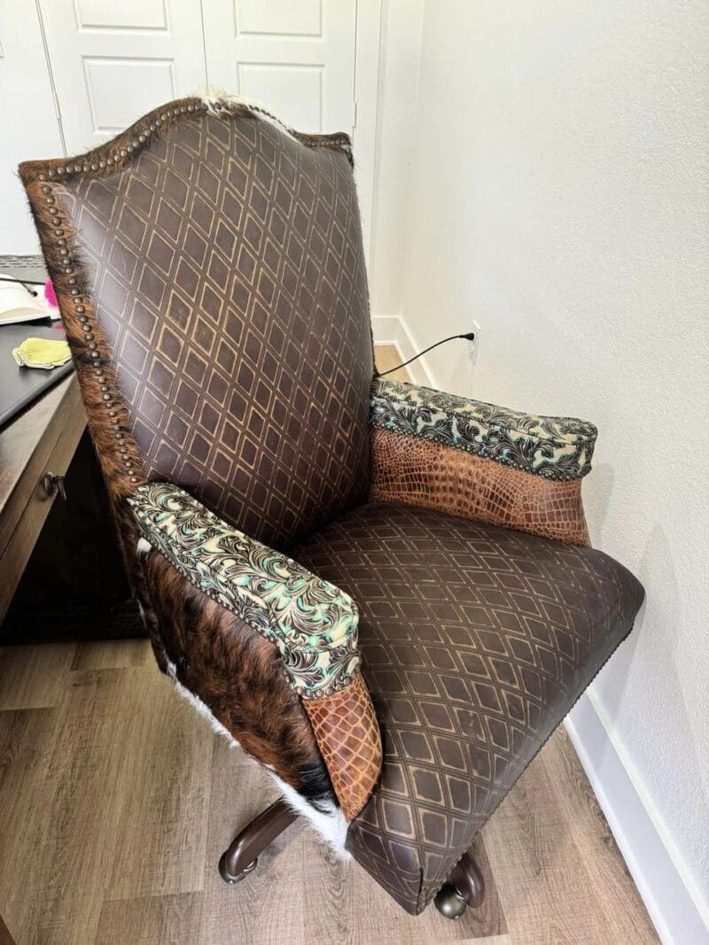 Brown leather office chair with patterned arms.