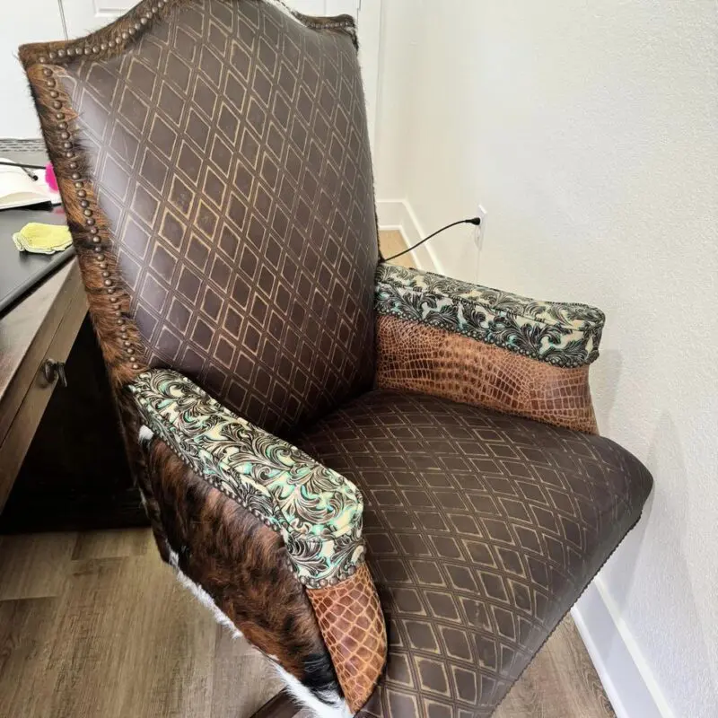 Brown leather office chair with patterned arms.