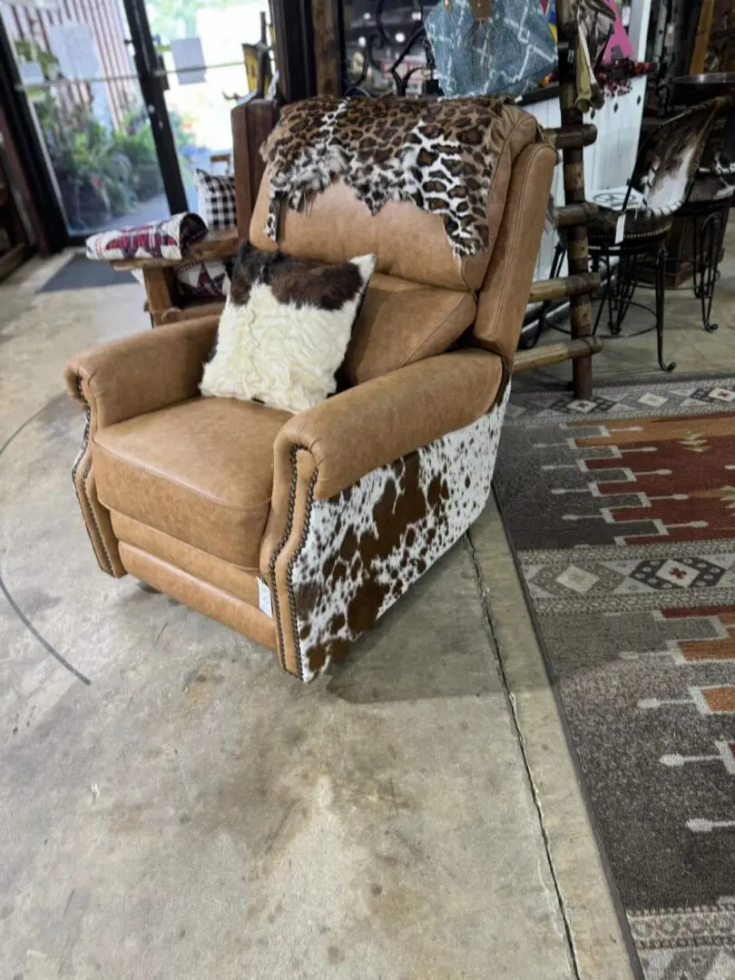 Brown leather recliner with cowhide accents.