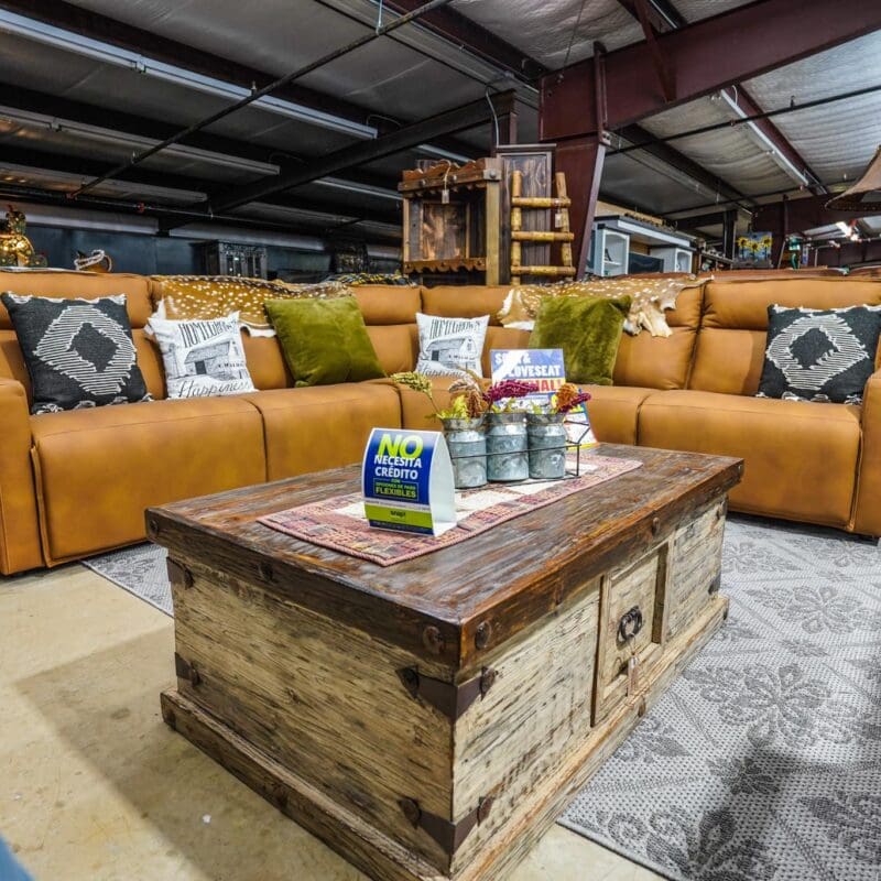 Leather sectional sofa with coffee table and rug.