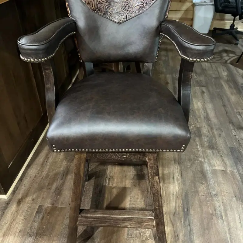 Brown leather bar stool with floral design.