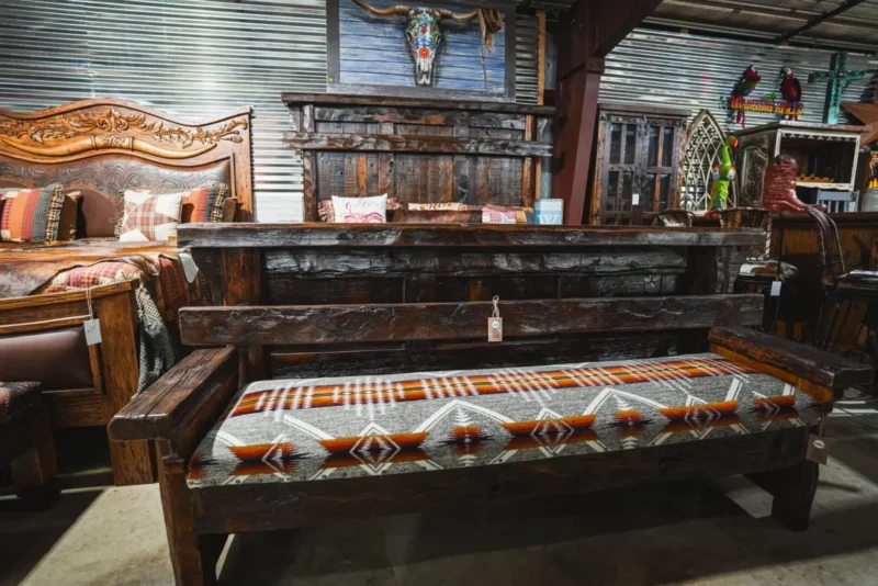 Rustic wooden bench with patterned cushion.