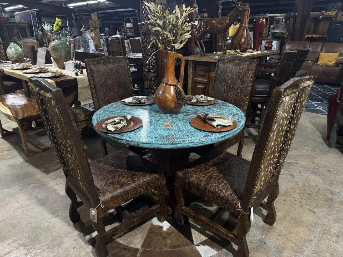 Rustic wooden dining set with leather chairs.